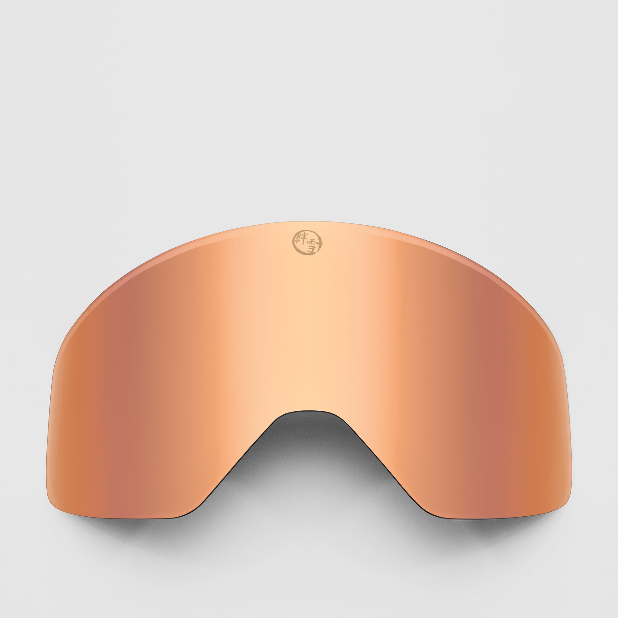 Rose gold ski goggles lens on a light gray background