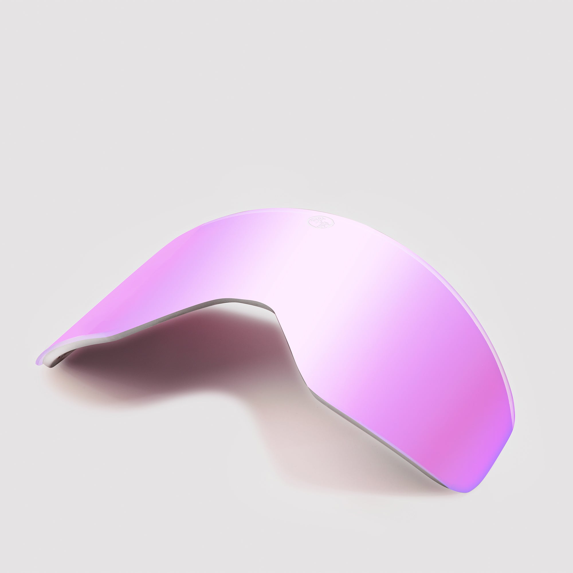 Angled pink ski goggles lens on a light gray background