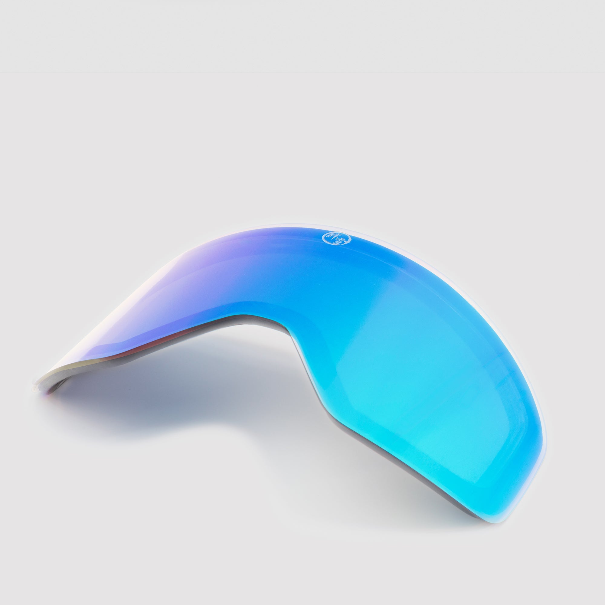 Angled blue ski goggles lens on a light gray background