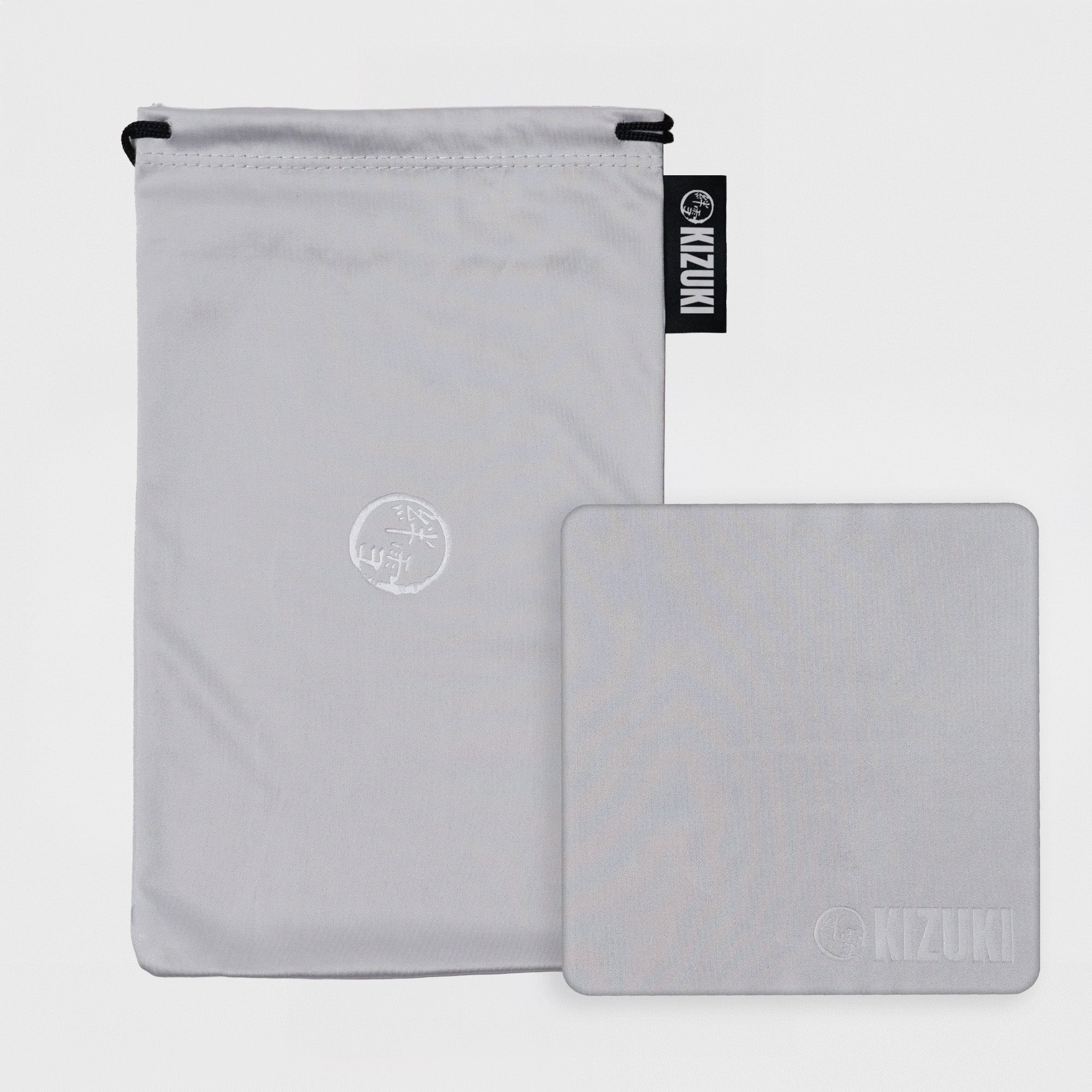 KIZUKI grey microfibre pouch & cloth on a grey background