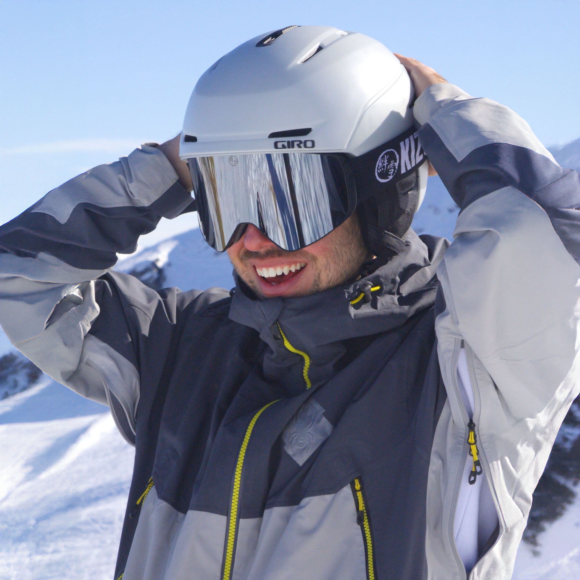 Person wearing a ski helmet and goggles with a snowy background