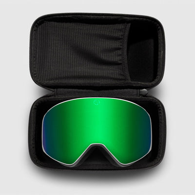 Green reflective ski goggles, with white frame in a black case on a light gray background
