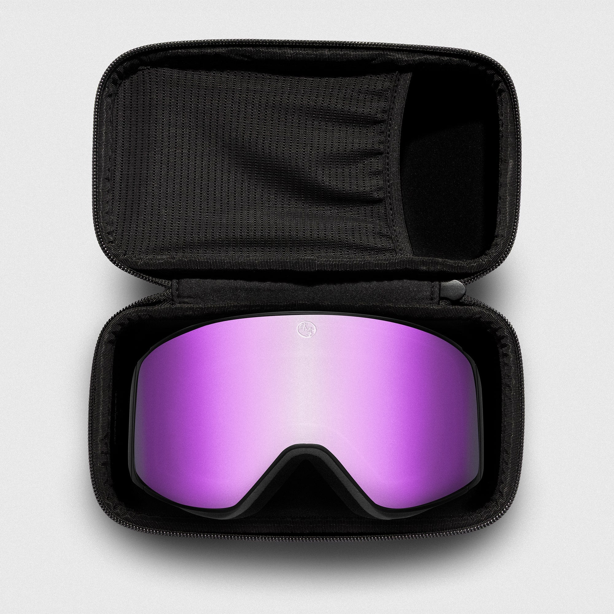 Pink, slim reflective ski goggles, with black frame in a black case on a light gray background