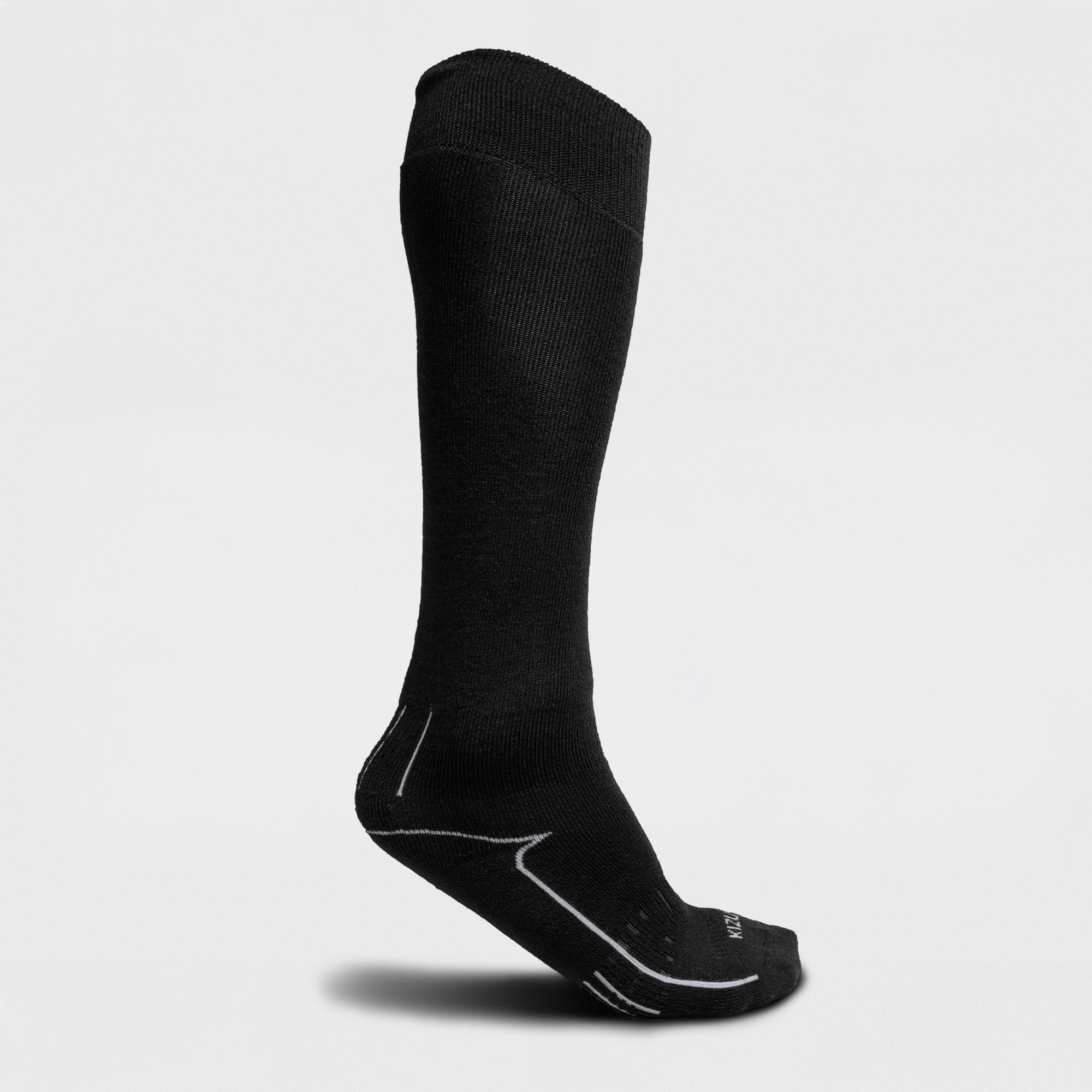Black knee-high ski sock on a light gray background