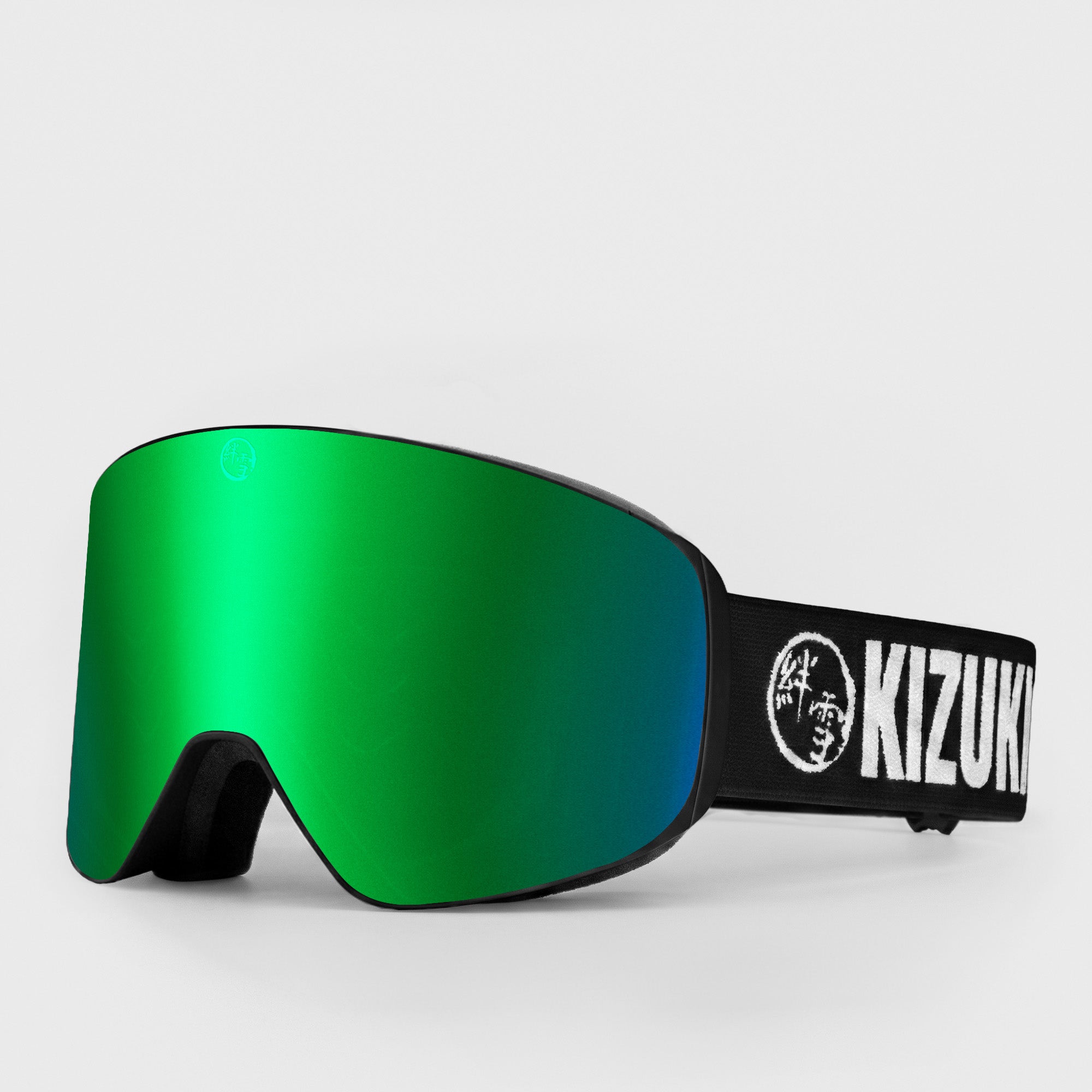 Green ski goggle in standard size with black strap featuring 'KIZUKI' brand on a light gray background
