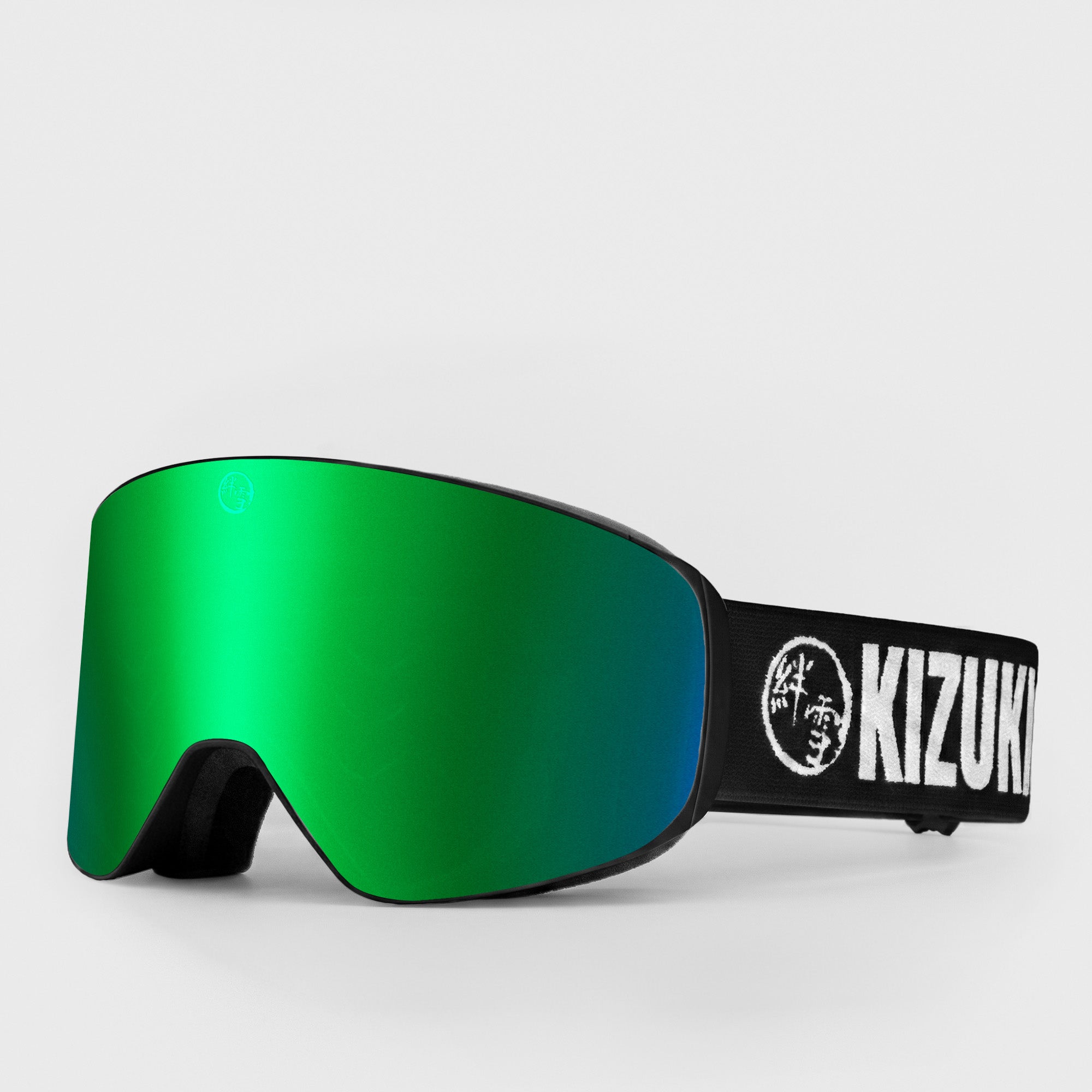Green ski goggle in slim size with black strap featuring 'KIZUKI' brand on a light gray background