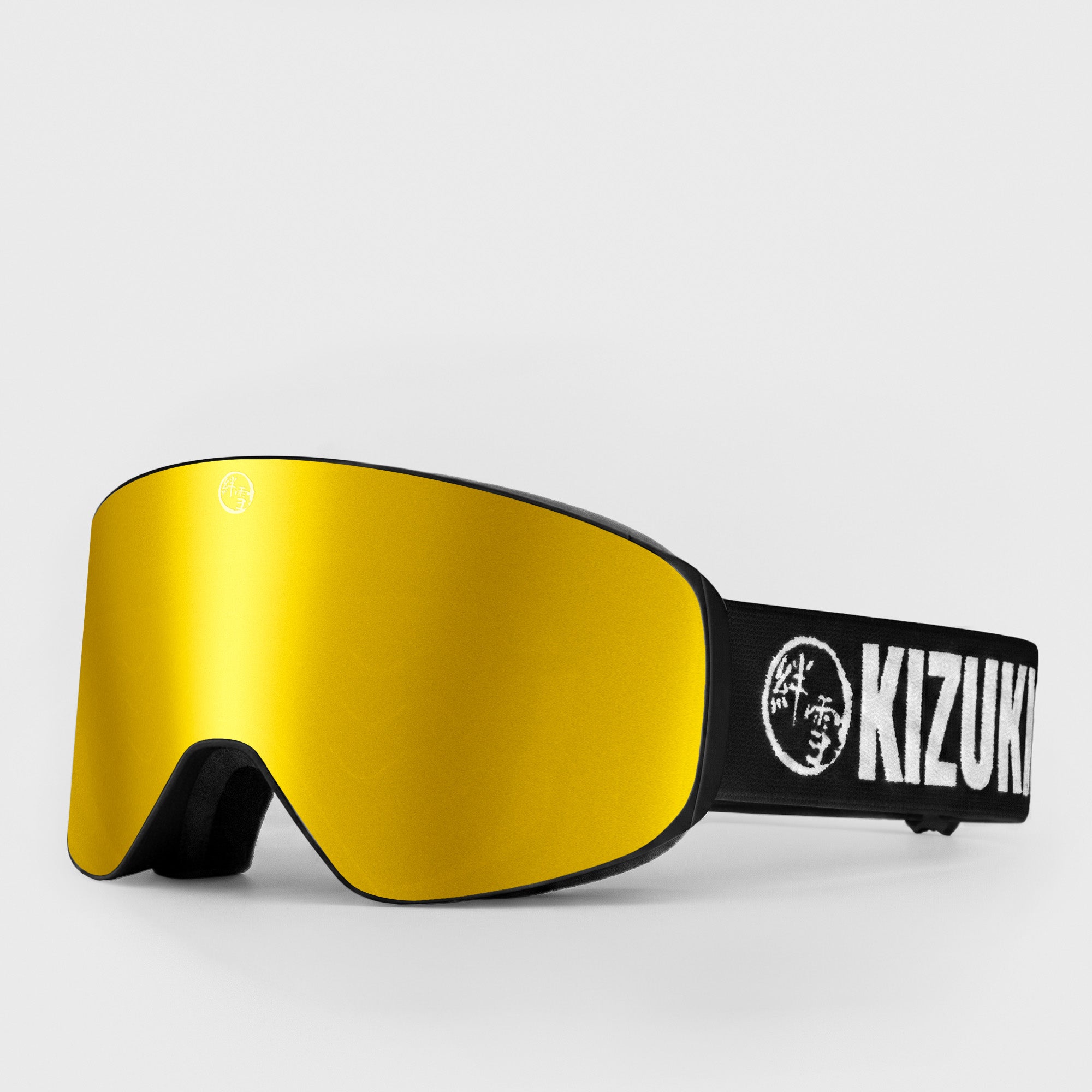 Gold ski goggle in slim size with black strap featuring 'KIZUKI' brand on a light gray background