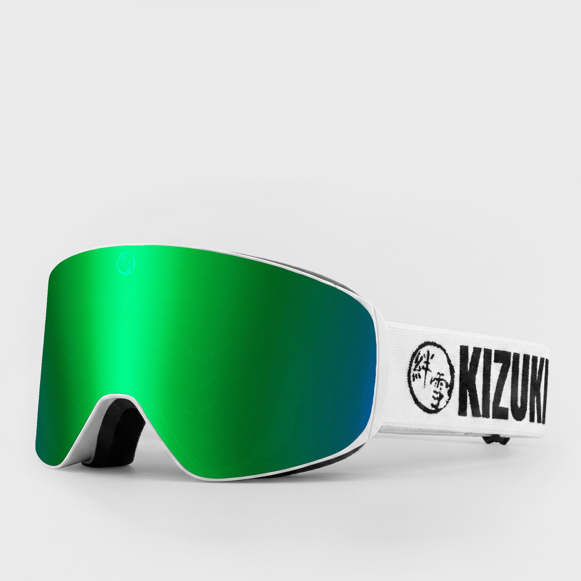 Green ski goggle in slim size with white strap featuring 'KIZUKI' brand on a light gray background
